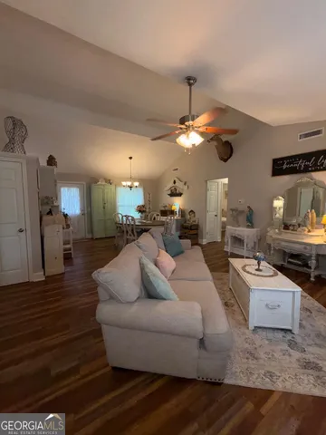 a living room with furniture and a chandelier