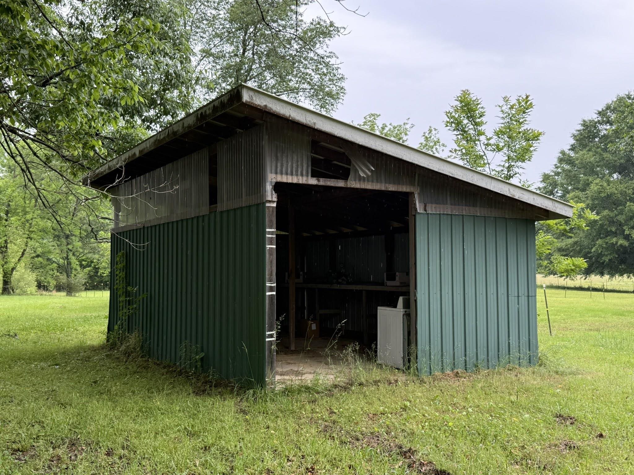 2102 Campbell Road Millington, TN 38053 - Photo 15 of 18 Metal-sided utility shed with an open-air bay, corrugated metal roofing, and a gravel base