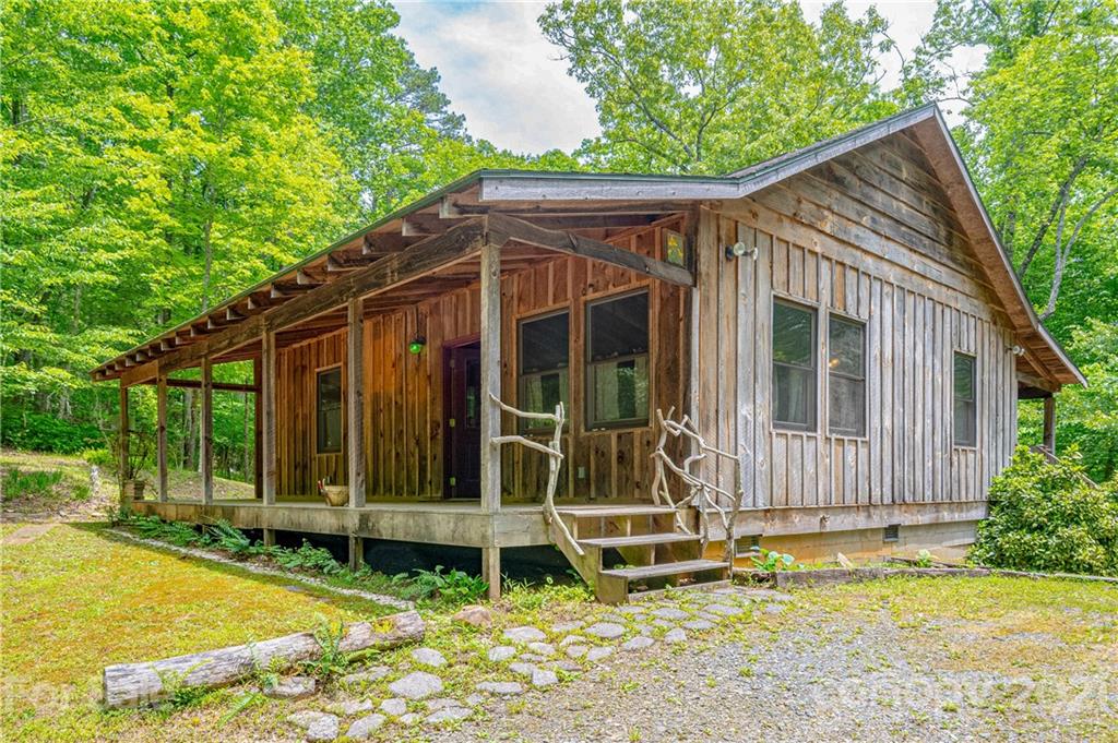84 Blossom Road Brevard, NC 28712 - Photo 1 of 19 a view of wooden house with a small yard