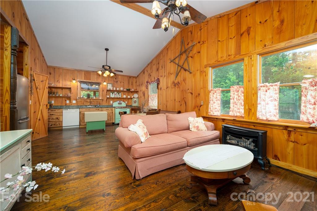 84 Blossom Road Brevard, NC 28712 - Photo 3 of 19 a living room with fireplace furniture and a large window