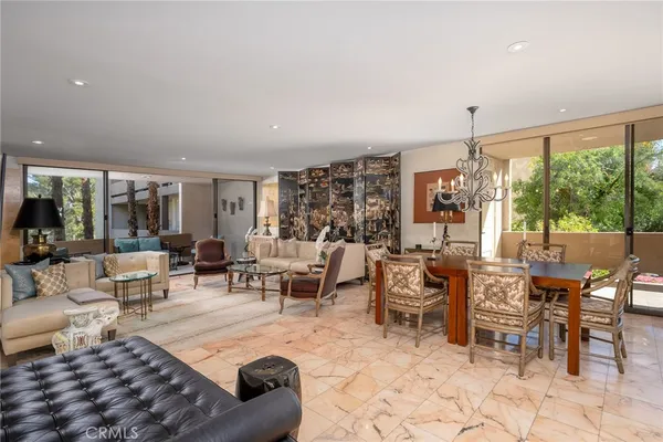 a living room with lots of furniture and a large window
