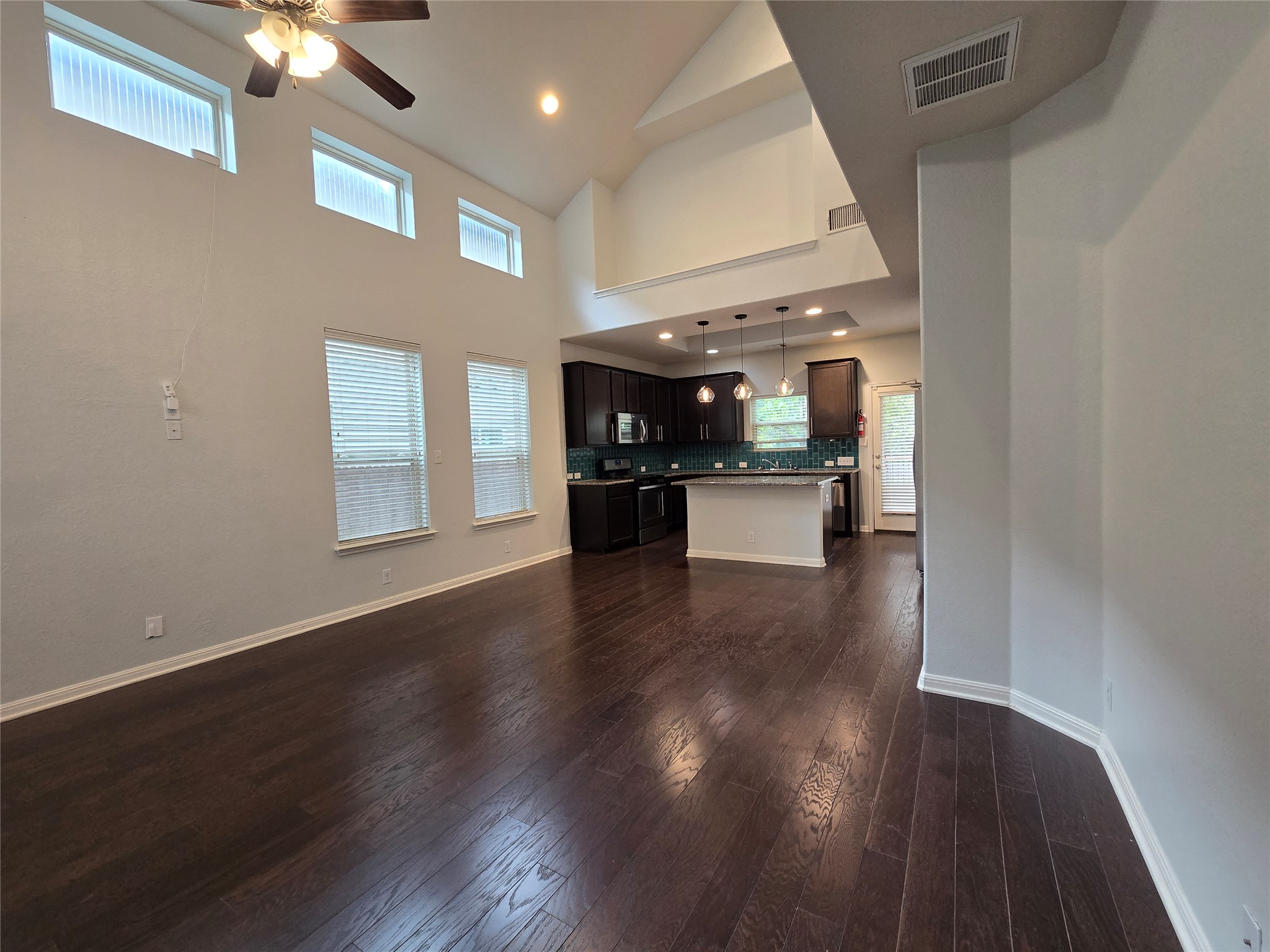 7337 Menchaca Road, Unit #22 Austin, TX 78745 - Photo 5 of 25 Unfurnished living room with recessed lighting, wood finished floors, high vaulted ceiling, and a ceiling fan