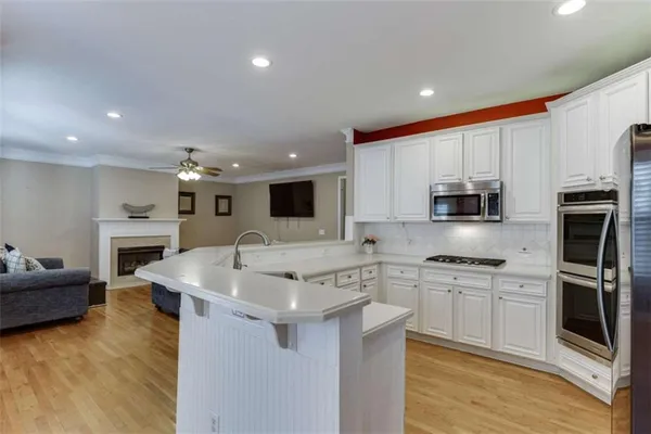 a kitchen with a sink stove and cabinets