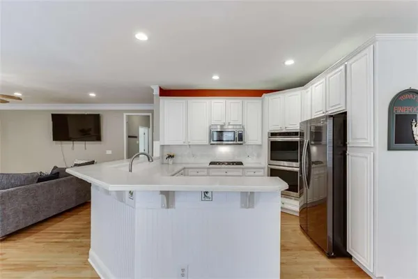 a view of a kitchen cabinets and a refrigerator