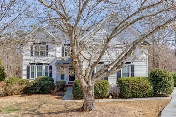 a front view of a building with a yard