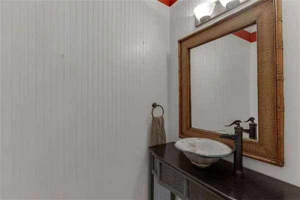 a view of an empty room with wooden floor and window