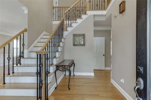a view of entryway and hall with wooden floor