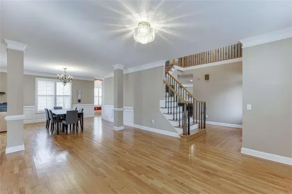 a view of a dining room with furniture wooden floor and chandelier
