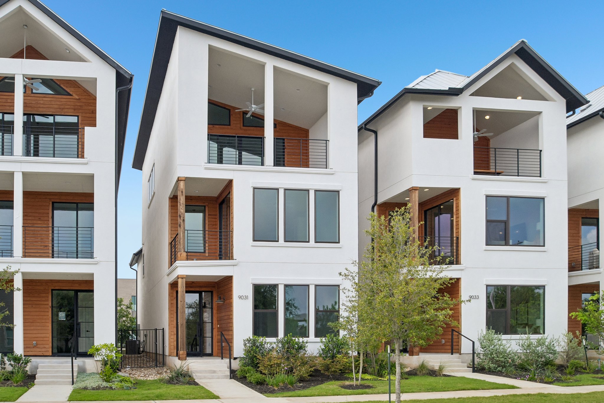 9031 Cattle Baron Path Austin, TX 78747 - Photo 2 of 31 Clean lines and wood accents define these striking, modern multi-story homes with private balconies.