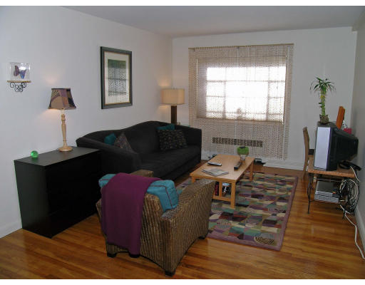 75 Strathmore Road, Unit 4 Boston, MA 02135 - Photo 2 of 13 a living room with furniture window and a flat screen tv