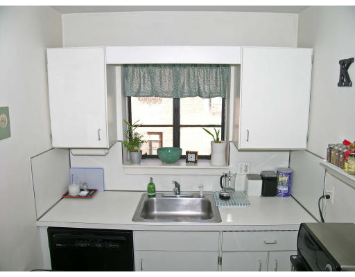 75 Strathmore Road, Unit 4 Boston, MA 02135 - Photo 4 of 13 a kitchen with a sink cabinets and window