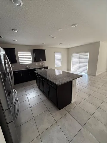 a kitchen with a sink a counter top space and cabinets