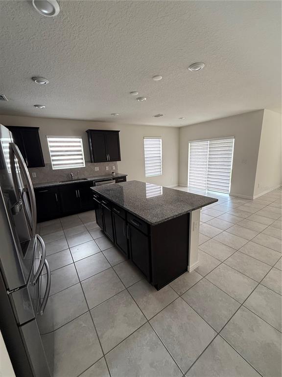 619 Citrus Isle Boulevard Davenport, FL 33837 - Photo 12 of 21 a kitchen with a sink a counter top space and cabinets