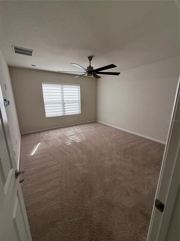 619 Citrus Isle Boulevard Davenport, FL 33837 - Photo 16 of 21 a view of a livingroom with a ceiling fan and window