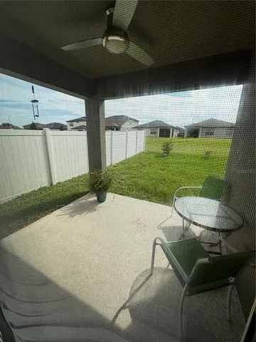a view of a backyard with table and chairs