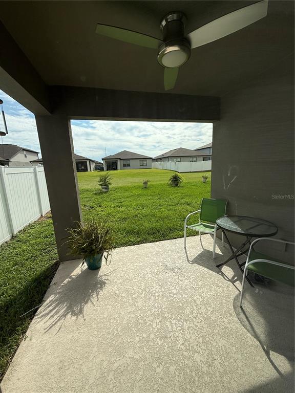 619 Citrus Isle Boulevard Davenport, FL 33837 - Photo 21 of 21 a view of a backyard with table and chairs