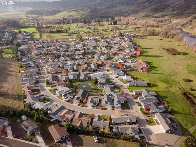 an aerial view of residential houses with outdoor space