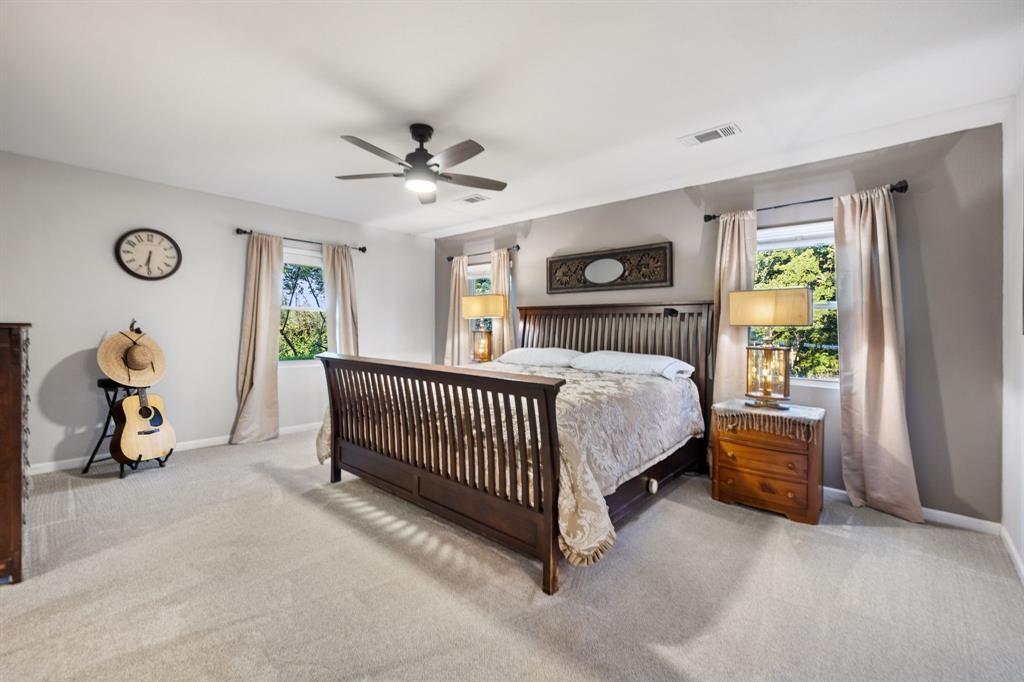 635 Old Justin Road Argyle, TX 76226 - Photo 12 of 36 a bedroom with a bed and a chandelier