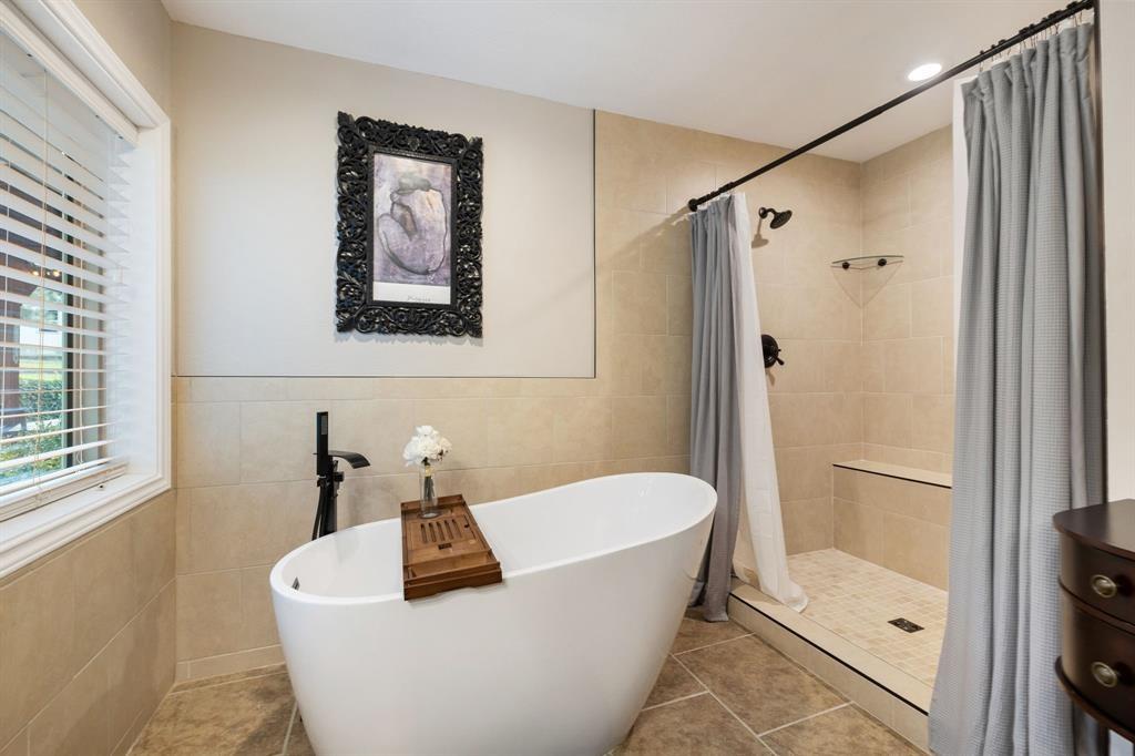 635 Old Justin Road Argyle, TX 76226 - Photo 15 of 36 a bathroom with a tub and shower