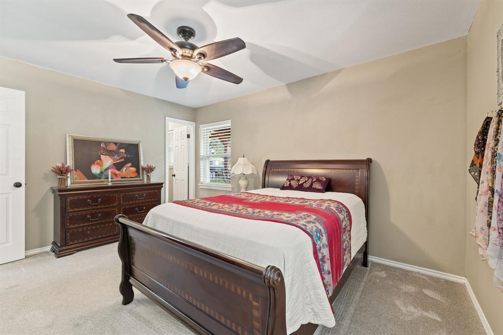 635 Old Justin Road Argyle, TX 76226 - Photo 16 of 36 a bedroom with a bed and a chandelier