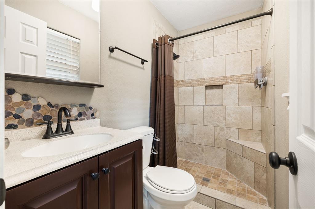 635 Old Justin Road Argyle, TX 76226 - Photo 17 of 36 a bathroom with a sink a toilet and shower