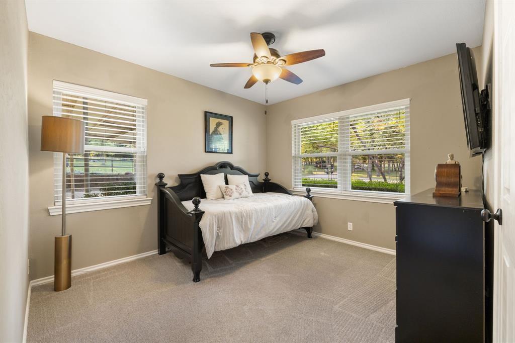 635 Old Justin Road Argyle, TX 76226 - Photo 18 of 36 a bed room with a bed and a flat tv screen