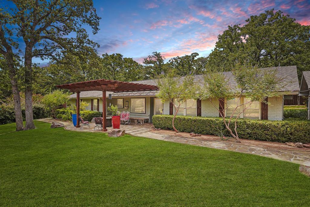 635 Old Justin Road Argyle, TX 76226 - Photo 3 of 36 a view of a park that has a table and chairs under an umbrella