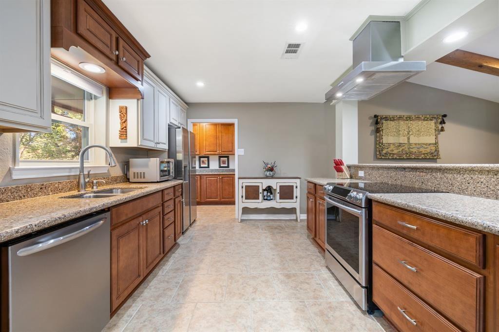 635 Old Justin Road Argyle, TX 76226 - Photo 6 of 36 a large kitchen with stainless steel appliances granite countertop a lot of counter space and a sink