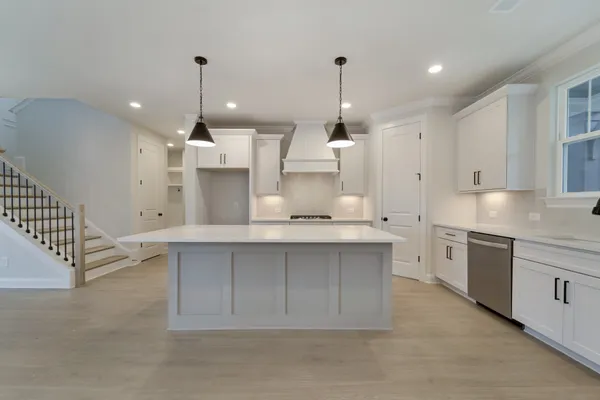 a kitchen with granite countertop a sink and a stove top oven