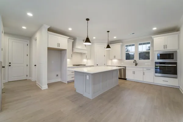 a kitchen with a sink stove and cabinets
