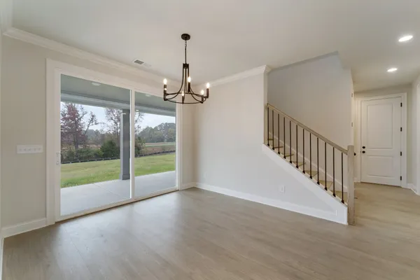 an empty room with windows and fireplace