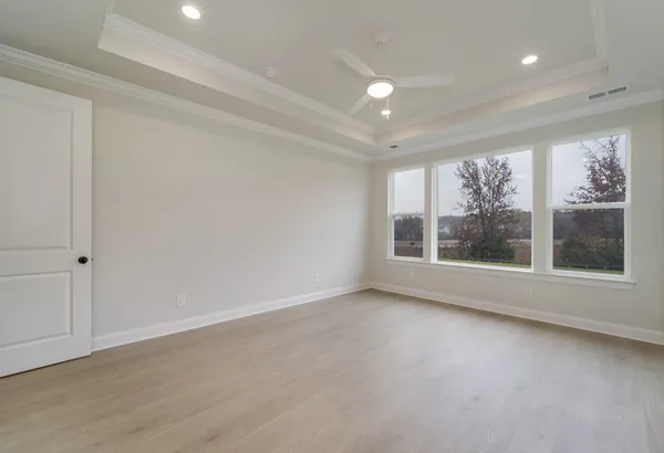 a spacious bathroom with double vanity sink a two mirror a window a bathtub and vanity