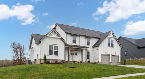 a front view of a house with a garden and plants