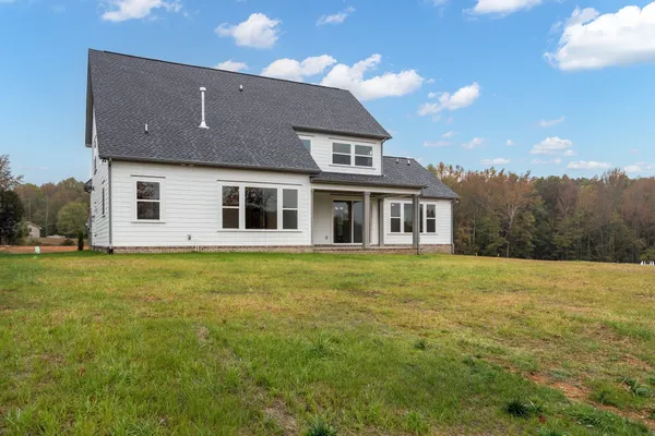 a house with swimming pool in front of it