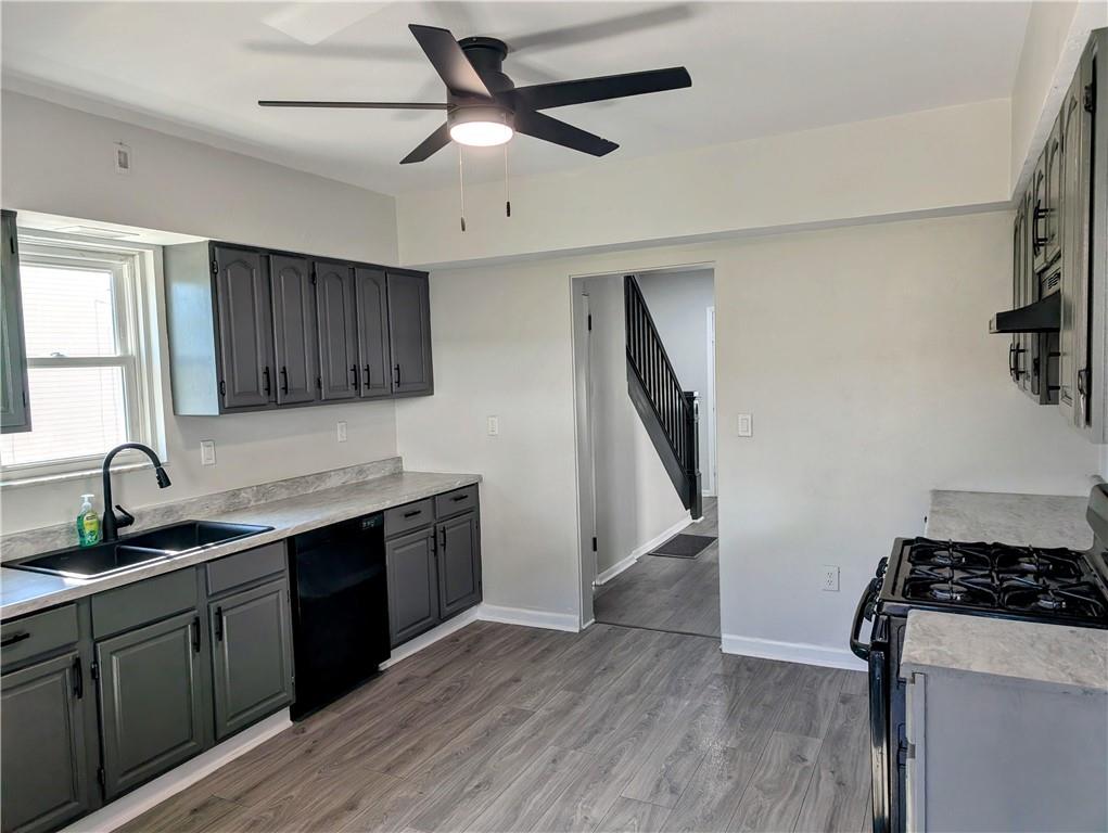 643 Indiana Avenue Glassport, PA 15045 - Photo 6 of 32 a kitchen with stainless steel appliances granite countertop a sink stove and refrigerator