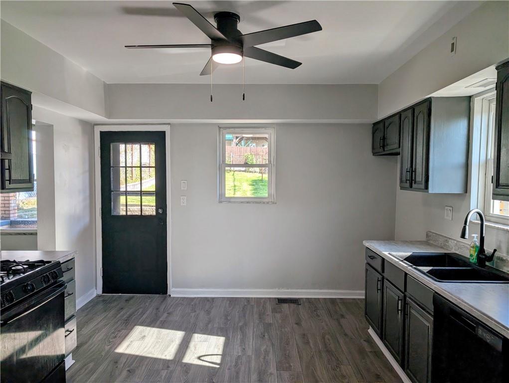 643 Indiana Avenue Glassport, PA 15045 - Photo 7 of 32 a kitchen with stainless steel appliances a stove microwave and a refrigerator