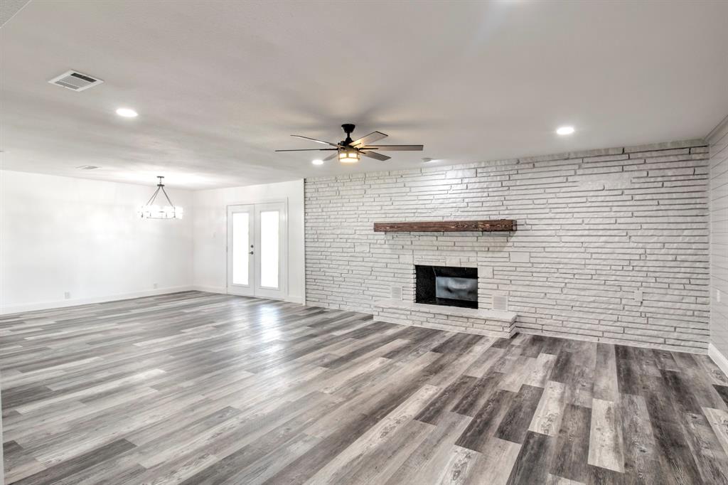 3884 Lois Road East Sanger, TX 76266 - Photo 11 of 40 an empty room with windows and a fireplace