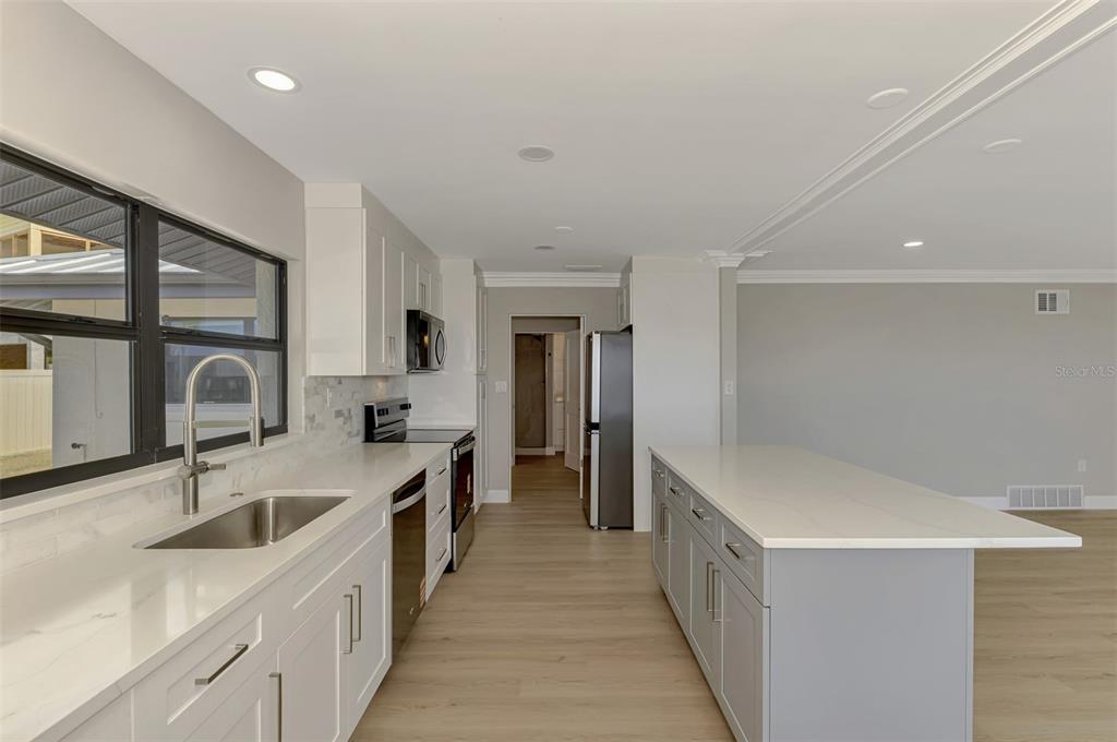 1822 Riverside Drive East Bradenton, FL 34208 - Photo 11 of 46 a kitchen with a sink and a refrigerator