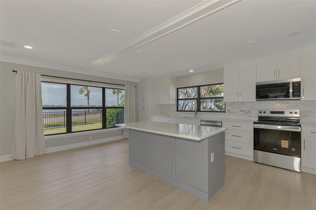 1822 Riverside Drive East Bradenton, FL 34208 - Photo 14 of 46 a large white kitchen with a large window