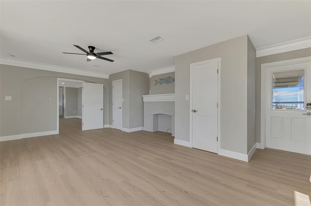 1822 Riverside Drive East Bradenton, FL 34208 - Photo 19 of 46 a view of empty room with wooden floor and ceiling fan