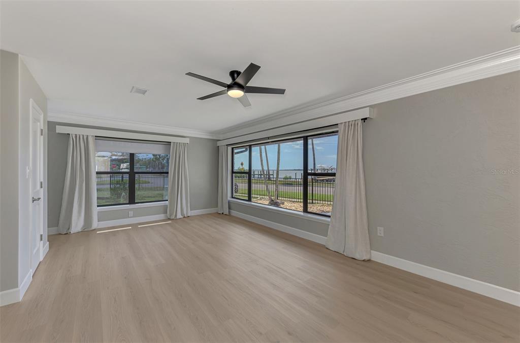 1822 Riverside Drive East Bradenton, FL 34208 - Photo 21 of 46 a view of empty room with wooden floor and fan