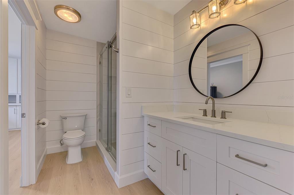 1822 Riverside Drive East Bradenton, FL 34208 - Photo 23 of 46 a bathroom with a toilet a sink and a mirror