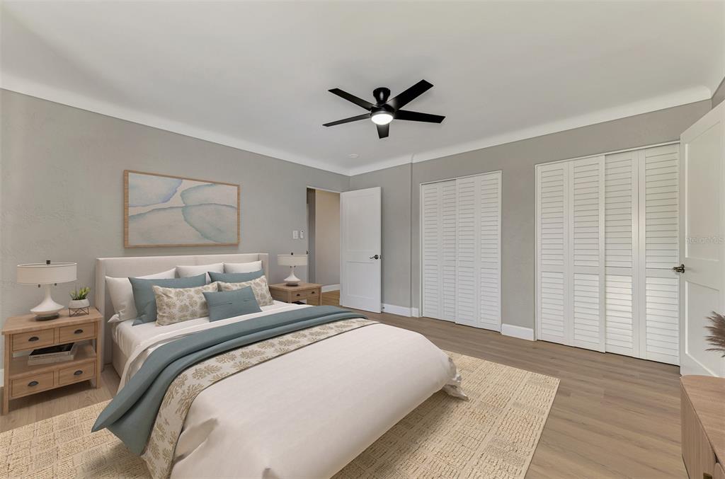 1822 Riverside Drive East Bradenton, FL 34208 - Photo 24 of 46 a bedroom with a large bed and a chandelier