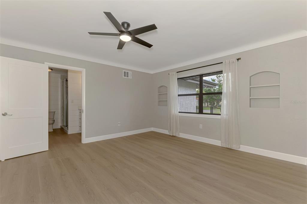 1822 Riverside Drive East Bradenton, FL 34208 - Photo 25 of 46 a view of an empty room with a window and wooden floor