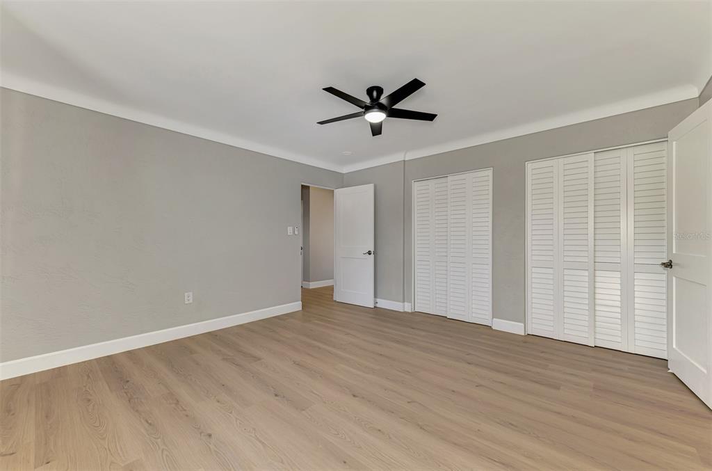 1822 Riverside Drive East Bradenton, FL 34208 - Photo 26 of 46 a view of empty room with wooden floor and ceiling fan