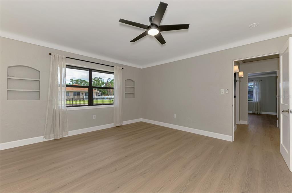 1822 Riverside Drive East Bradenton, FL 34208 - Photo 27 of 46 wooden floor in an empty room with a window