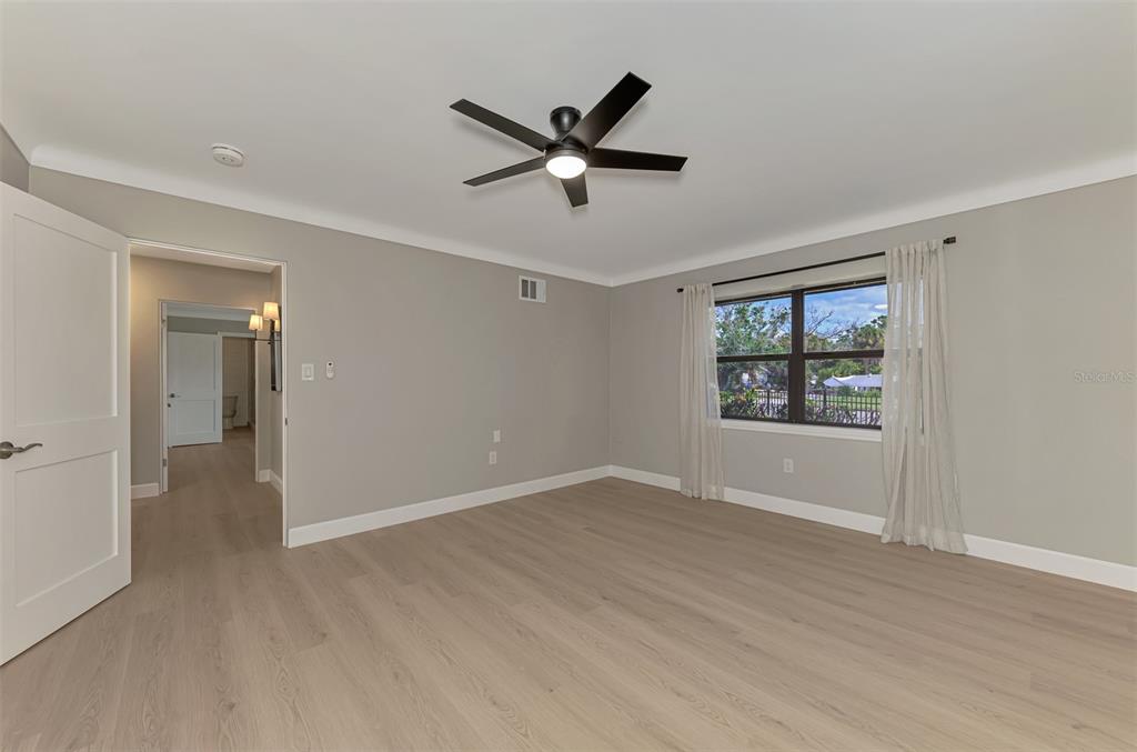 1822 Riverside Drive East Bradenton, FL 34208 - Photo 28 of 46 a view of empty room with wooden floor and ceiling fan
