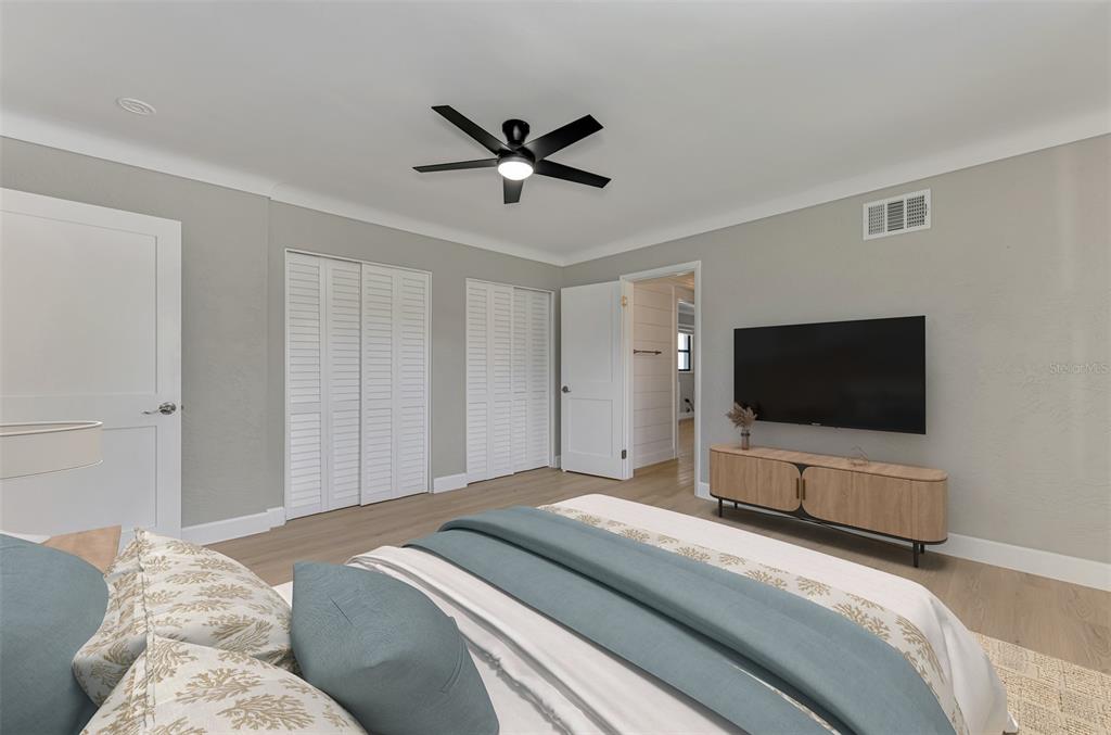 1822 Riverside Drive East Bradenton, FL 34208 - Photo 31 of 46 a bedroom with a bed and a flat screen tv