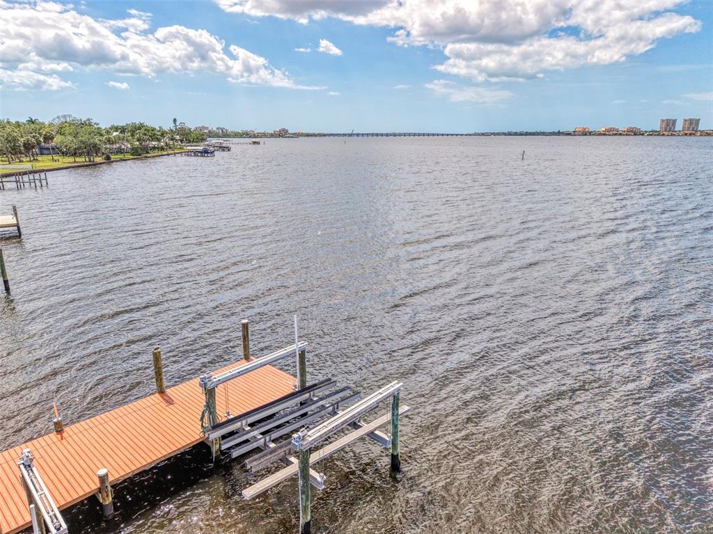 1822 Riverside Drive East Bradenton, FL 34208 - Photo 39 of 46 a wooden bench sitting next to a lake