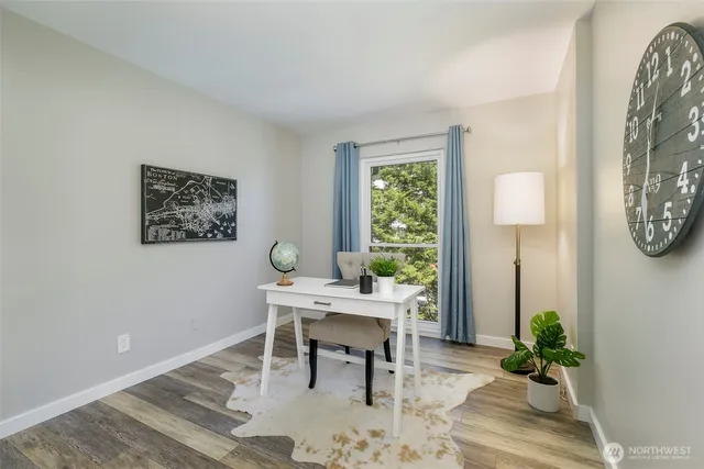 a view of a workspace room with wooden floor